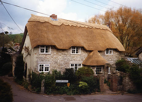 Rethatched house in combed wheat reed, Osmington Dorset